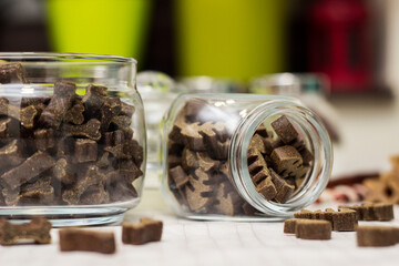 Dog treats spilling out of bowl. Dog treats and biscuits