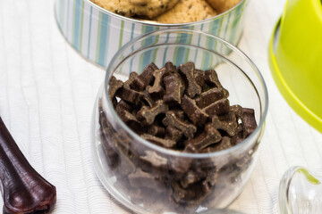 Dog treats spilling out of bowl. Dog treats and biscuits