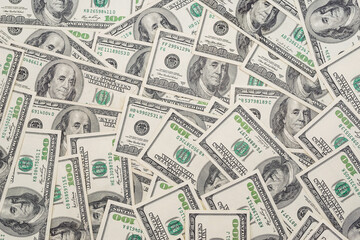 Heap of old design dollar bills as background.