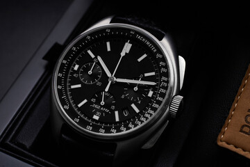 Black luxury watch on black background