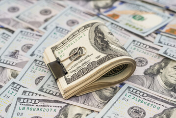 dollars with metal clip on dollars background