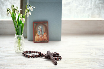 cross, rosary beads, flowers, orthodox icon and bible books. concept of faith, God, orthodox Church...