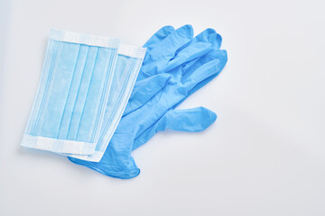 Prevent coronavirus. Medical protective mask and disposable gloves isolated on white background. Disposable surgical face mask cover mouth and nose. Healthcare medical Coronavirus quarantine.