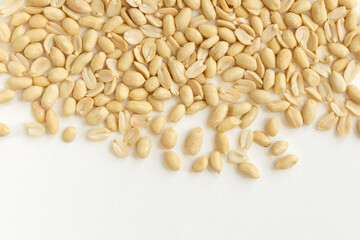 Arranged peanuts peeled and isolated on white background.