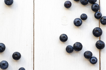 Blueberries on a white wooden backdrop. 