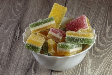 Multi colored layered marmalade in a dish. Closeup of wonderful dessert.