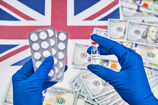 Researcher Hand In Blue Gloves Holding Coronavirus, Covid-19 Vaccine Against Background Of Flag Of England And Money Disease Preparing For Human Clinical Trials Vaccination Shot, Medicine Concept.