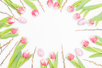 Obraz na płótnie Canvas Flat lay easter composition with pink tulips and eggs on white background