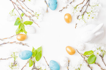 Flat lay easter composition with spring flowers and eggs on white background