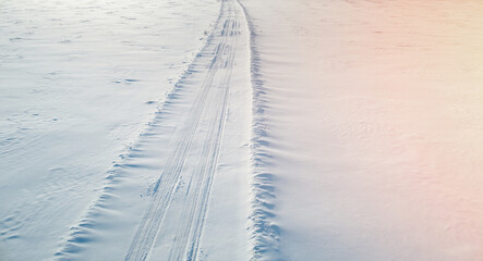 Car traces on snow field