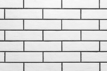 The texture of the white clean brick with black grout