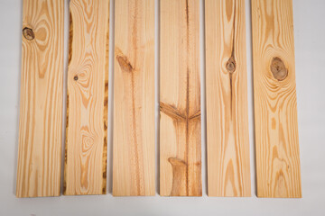 Unfinished raw pine lumber on a solid white background