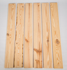 Unfinished raw pine lumber on a solid white background - obrazy, fototapety, plakaty