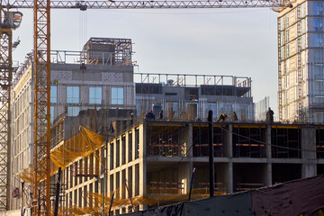 tower cranes on the construction site of multi-storey residential buildings