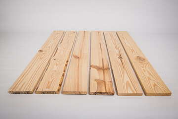 Unfinished raw pine lumber on a solid white background