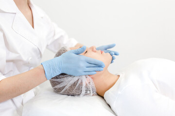 Cosmetologist giving a girl a facial massage