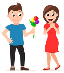 A man gives flowers to a happy woman in a dress. Valentines Day