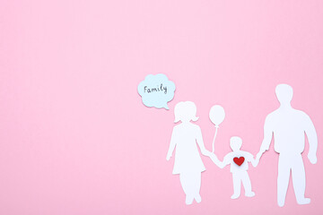 Family figures with red heart and speech bubble on pink background
