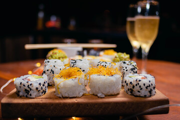 close-up of sushi food on wooden base with dark background for valentine's day dinner with champagne glasses cordoba argentina