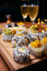 close-up of sushi food on wooden base with dark background for valentine's day dinner with champagne glasses cordoba argentina