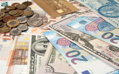 close up image of credit card, coins and banknotes of different currencies