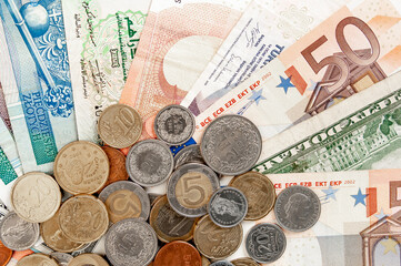 close up image of coins and banknotes of different currencies