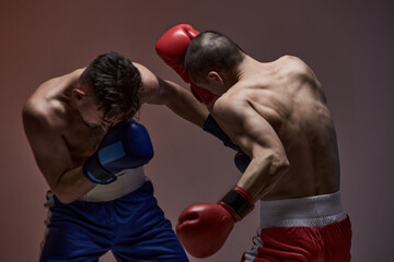 Fototapeta na wymiar Wrestling of two fighting males, boxers during battle, knockout, martial arts, mixed fight concept