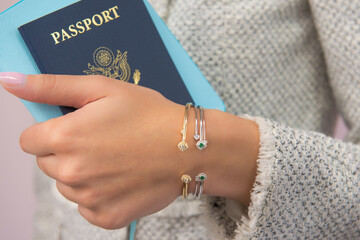 Obraz na płótnie Canvas Woman holding passport with jewelry