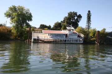 Fototapeta na wymiar Half Sunken Riverboat on California Delta Waterway