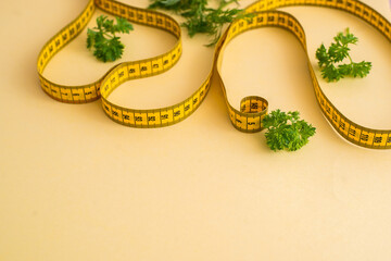 Diet concept on yulow background with measuring tape isolated