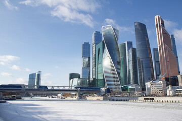 City landscape in sunny winter day with the view of the Moscow-City buildings and frozen river