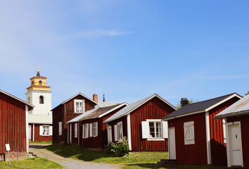 View of the Gammelstad church town huts with the church tower in the background.