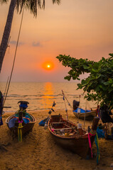 Traditional long tail boat on Pattaya beach at sunset, Thailand