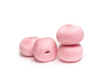 Pink skeins of wool yarn on a white insulated background. Balls of wool for knitting