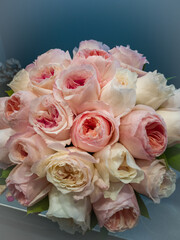 A bouquet of delicate pink roses close-up on a gray background 
