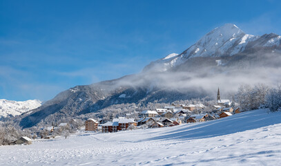 The village of Saint Leger les Melezes in the Champsaur Valley covered in snow in winter. Ski resort in the Ecrins National Park, French Alps, Hautes Alpes, France