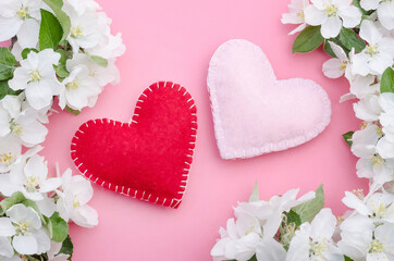 Valentines day card, two hearts on a pink background with flowers