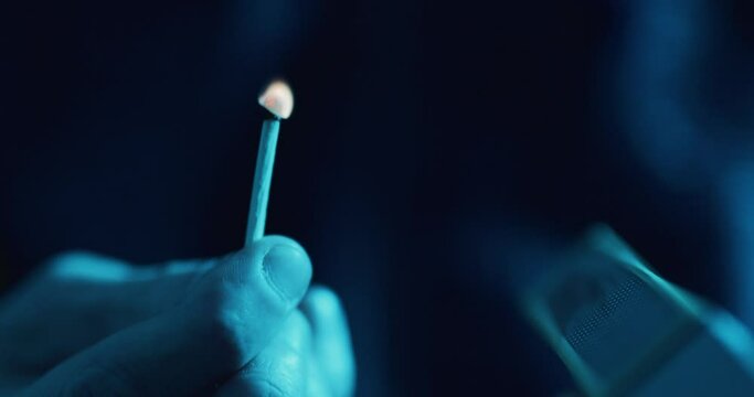 Striking a match on side of matchbox - macro close up 