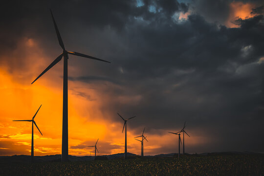 wind turbines at sunset in bad weather