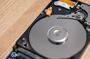 Close up photo of the read and write head of a hard drive while it is working 