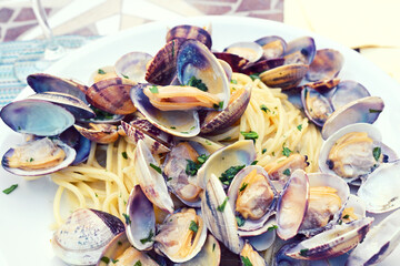plate of spaghetti with clams in a restaurant