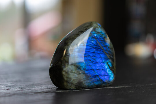 Labradorite mineral stone on slate worktop.