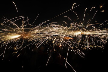 People playing with pyrotechnics in the street at a village. People having fun