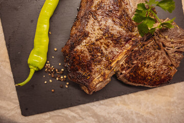 Freshly grilled T bone steak with vegetables. T-bone grilled beef steak with spices and herbs. Top...