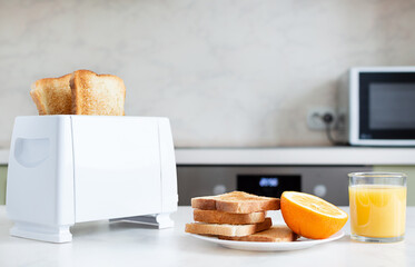 Served table for breakfast with toast, fruit, orange juice