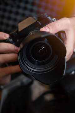 close up of hands holding a camera and taking a picture