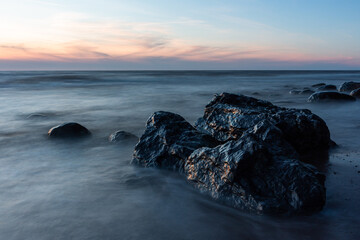 rocks by the sea at sunset