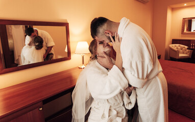 lovers in bathrobes in the bedroom