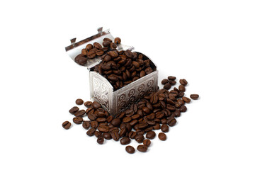 Roasted coffee beans in a small metal chest around it. Isolate on a white background. Copspace