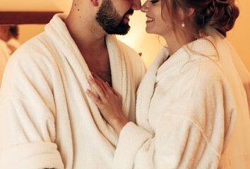 lovers in bathrobes in the bedroom